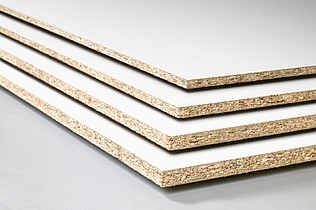 Image of 4 multiplex boards with white coating and of different thickness stacked on top of each other.