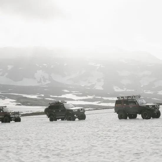 jeeps riding in snow landscape