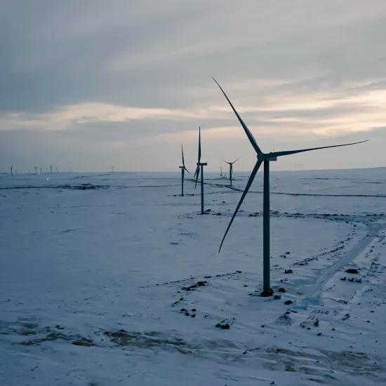 Wind turbines in cold snowy landscape