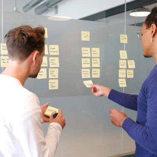 Man holds planning meeting with colleague