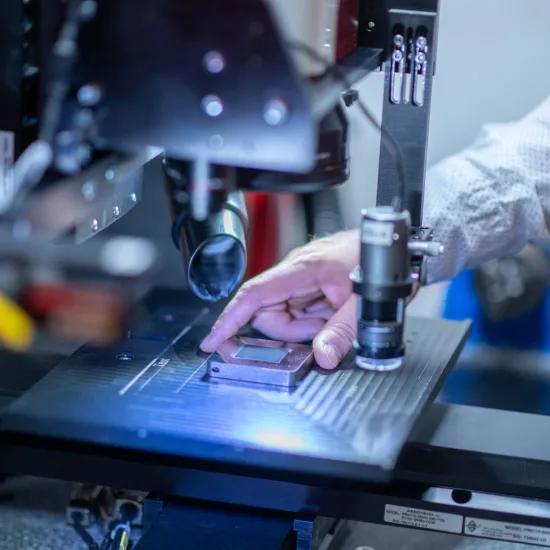 Engineer handling specimen in femtosecond laser for texturing surfaces