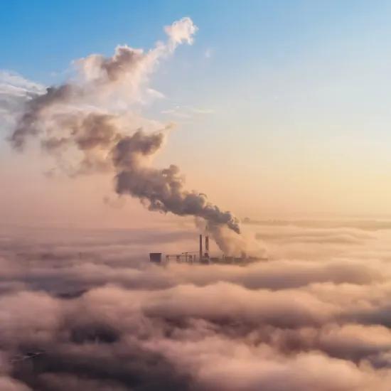 View of a thermal energy installation in the distance above the clouds, columns of steam