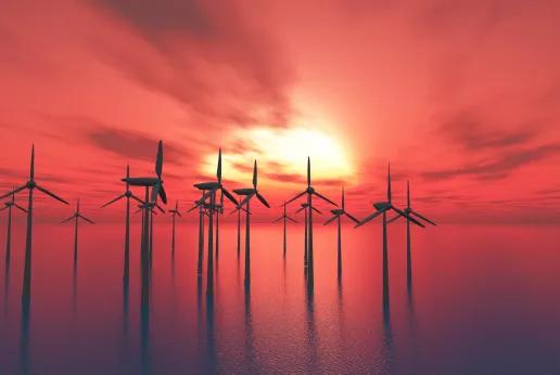 Offshore windmolens tegen zonsondergang