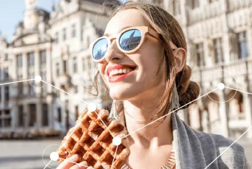 Woman smiling and eating a Belgian waffle on Brussels central square