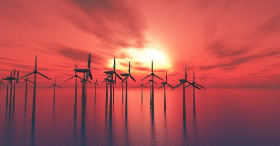 Offshore wind mills against sunset