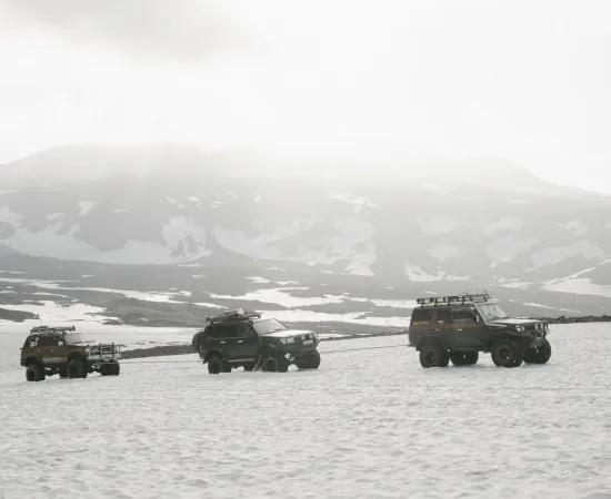 jeeps riding in snow landscape