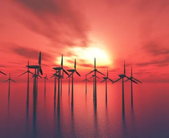 Offshore wind mills against sunset