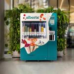 Alberts smart product smoothie vending machine in hallway in front of green plants against wall